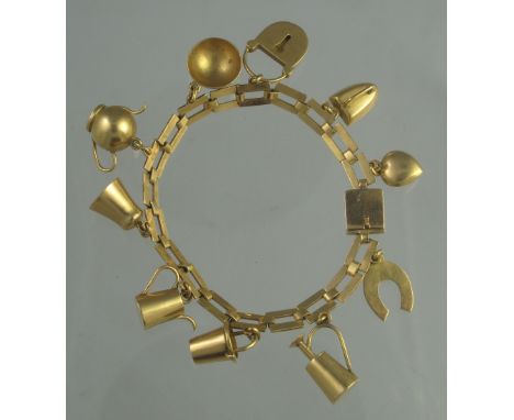 UNMARKED YELLOW GOLD CHARM BRACELET. Rectangular link bracelet with box clasp and ten charms, including; a horseshoe, teapot,