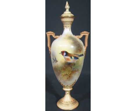 ROYAL WORCESTER PORCELAIN BLUSH IVORY TWO HANDLED LIDDED VASE of slender ovoid form, painted with bull finches in woods and s