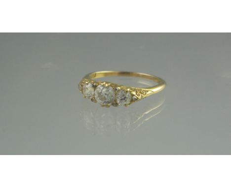 AN OLD CUT DIAMOND THREE STONE RING in scrolling engraved setting. ring size R, weight 4g approx. (B.P. 24% incl. VAT) CONDIT