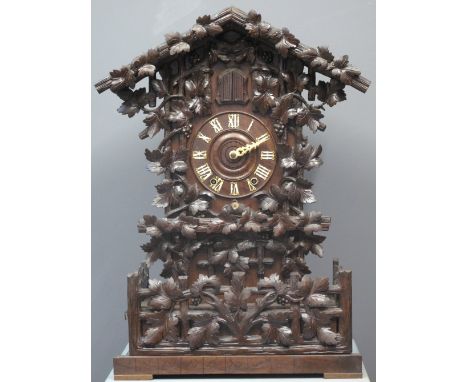 LATE 19TH CENTURY BAVARIAN TWO TRAIN MUSICAL CUCKOO CLOCK carved and stained wooden case overall decorated with trailing vine