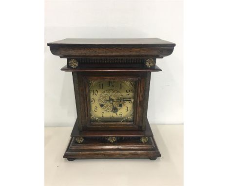Antique Oak Brass Face Mantle Clock measures approx 14ins tall by 11ins wide 
