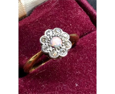 Antique opal and diamond ring set with small central opal with small diamonds around ring hallmarks are rubbed but tests as a