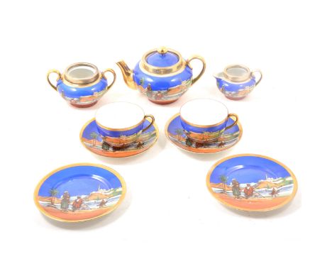 A Continental porcelain tea service, printed with an Arabian desert scene, silver-plated mounts to teapot, sugar bowl and mil