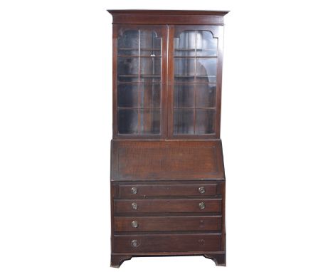 Edwardian mahogany bureau bookcase, moulded cornice, plain frieze, two glazed panelled doors to the upper section, enclosing 