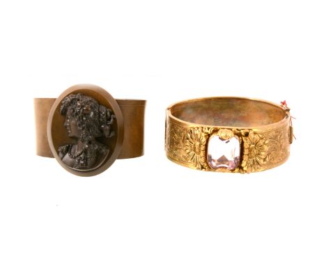 A gilt metal Victorian style half hinged bangle 25mm wide, engraved floral and scroll decoration to front and back, claw set 