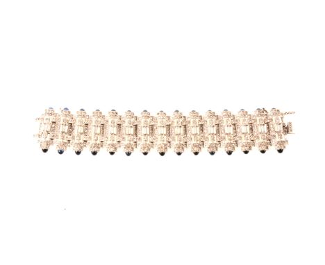 Art Deco paste set panel bracelet, fifteen links set with clear brilliant and baguette cut paste having a border of blue cabo