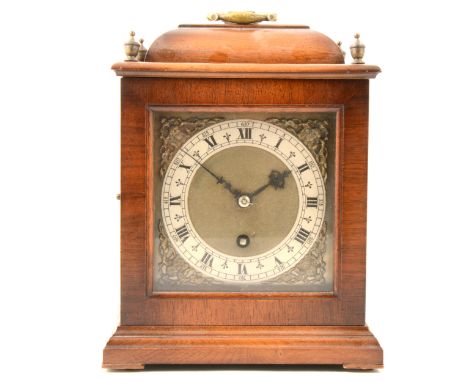 A reproduction walnut bracket clock, silvered chapter ring, cast spandrels, key-wind enclosed movement, 24cm.