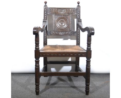 A Victorian carved oak elbow chair, carved panel back, drop-in rush seat, width 58cm, depth 62cm, height 98cm.