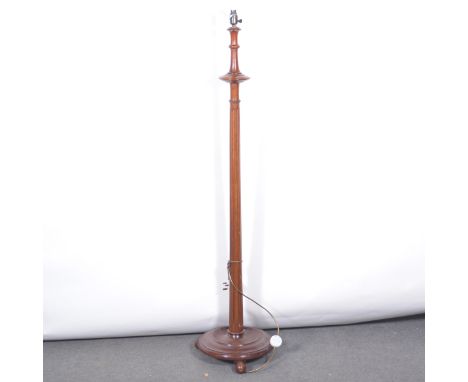 Mahogany standard lamp, fluted shaft, circular base.