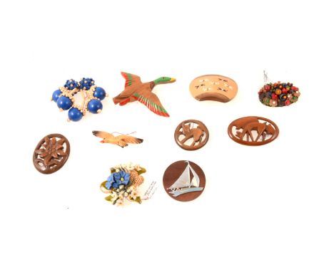 Ten vintage wooden brooches, racehorses 70mm, Bambi, mallard in flight 90mm, metal yacht on a circular wooden disc 50mm.