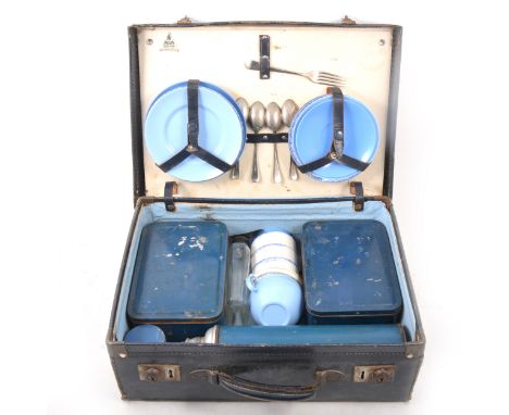 A vintage Harlequin picnic case, with two fitted tin sadwiches boxes, ceramic cups, Thermos etc, 41cm wide.
