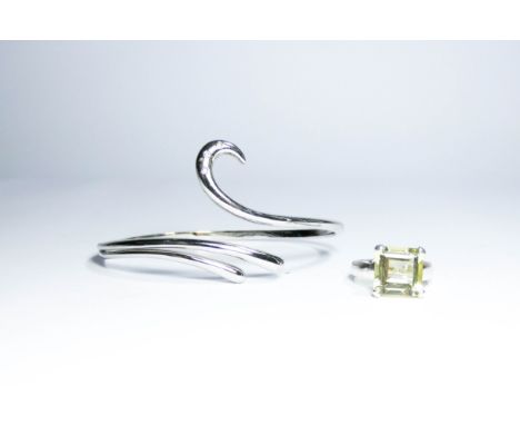 A silver bangle by White Ice set with three diamonds and a silver ring set with a yellow lemon topaz stone 