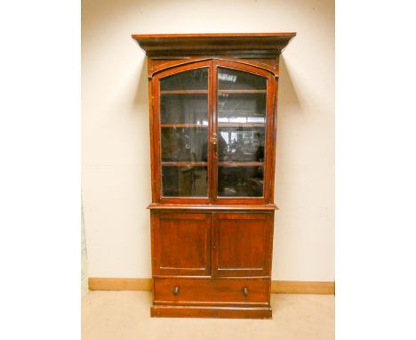 A stained mahogany glazed two door bookcase standing on a cupboard base with drawer under 3' wide 