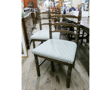 A set of ten oak ladder back style dining room chairs with green upholstered seats matching the previous lots 
