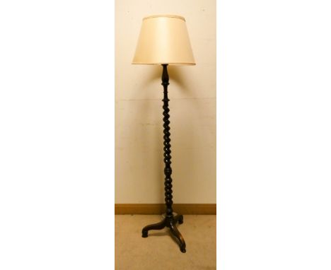 An oak barley twist column standard lamp on tripod base with gold coloured shade 