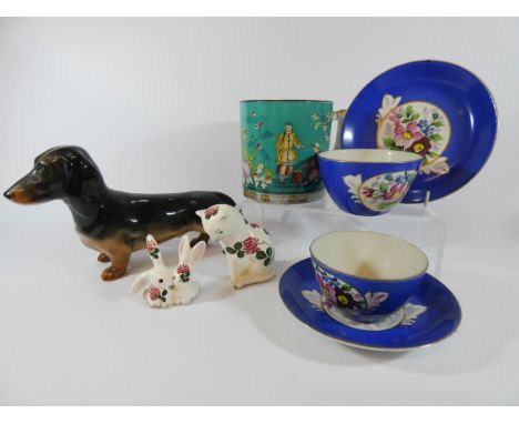 A collection of ceramics to include Plichta model of a cat and similar pair of rabbits, two Russian tea cups and saucers, Bes