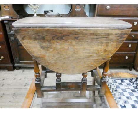 A small oval oak gate leg table on turned legs 23" wide 