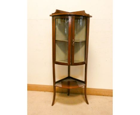 A small Edwardian bow fronted glazed two door china display cabinet with under tier 