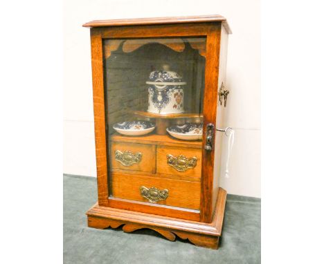 Edwardian oak smokers cabinet fitted three interior drawers and tobacco jar and dishes in oak and glazed case with bevelled g