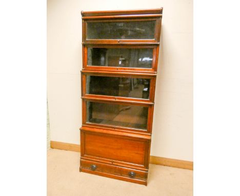 A mahogany Globe Wernicke four section glazed bookcase standing on a cupboard base with fold up door and drawer under   Heigh