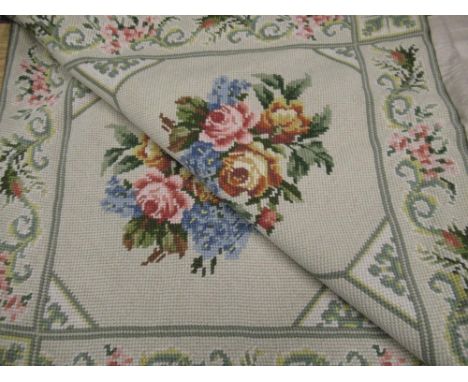 20th C woolwork rug, light green ground with rose pattern centre and scrolling floral pattern border approx 368cm x 250cm 