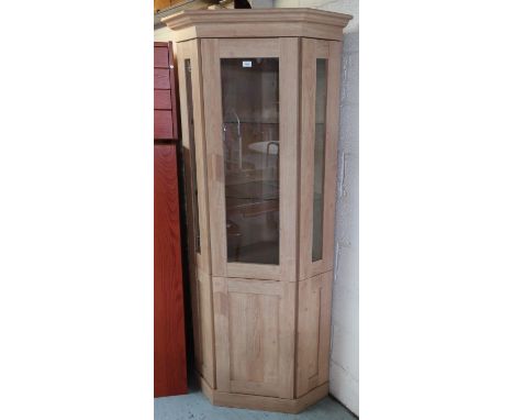 Light oak finish corner cabinet, with glazed upper and panelled lower doors (86cm x 195cm x 50cm) 