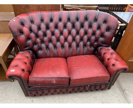 AN OXBLOOD BUTTON-BACK TWO SEATER SETTEE 