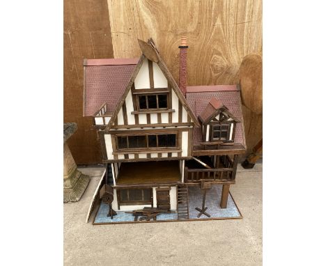 A LARGE VINTAGE WOODEN DOLLS HOUSE WITH AN ASSORTMENT OF DOLLS FURNITURE 