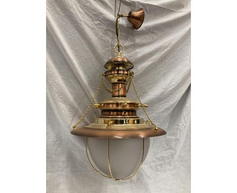 AN UNUSUAL BRASS AND COPPER PENDANT LIGHT WITH DOMED GLASS SHADE, SHIPS WHEEL DESIGN AND CHAINS 