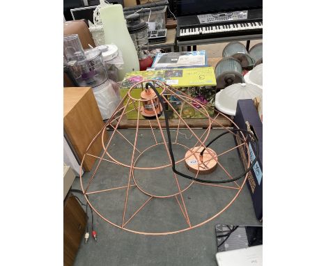 A DECORATIVE COPPER COLOURED LIGHT FITTING 