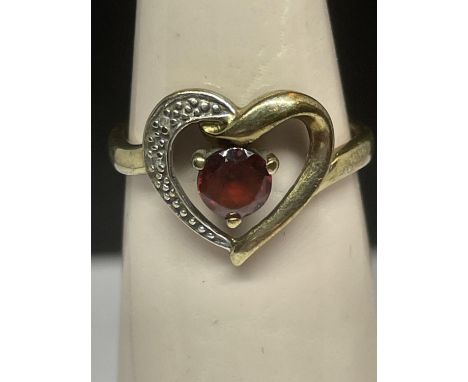 A 9 CARAT GOLD HEART DESIGN RING WITH A LARGE RUBY AND DIAMONDS SIZE M/N 