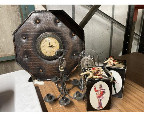 AN OCTAGONAL SHAPED CLOCK FRAMED WITH STUDDED FAUX LEATHER, A PAIR OF WALL MOUNTED METAL CANDLESTICKS, A GLASS DOMED MANTLE C
