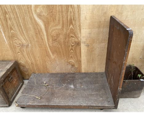 A VINTAGE FOUR WHEELED DOLLY BEARING THE LABEL 'GORTON PHILHARMONIC SOCIETY' 