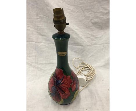 A MOORCROFT HIBISCUS ON GREEN LAMP 