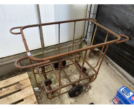A VINTAGE CAST IRON FOUR WHEELED LAUNDRY TROLLEY 