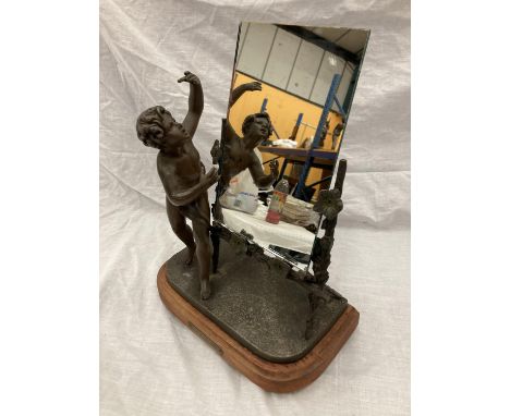 A VINTAGE FRENCH BRONZED FIGURE OF A BOY AND A TRELLIS OF FLOWERS SUPPORTING A MIRROR (MIRROR NOT ORIGINAL) 28.5CM LENGTH, HE