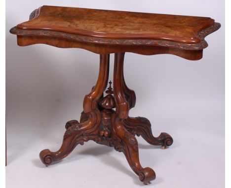 A Victorian figured walnut pedestal card table, the four quarter veneered fold-over top with swivel action, having a moulded 