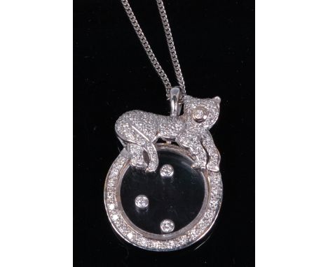A Chopard style 'happy diamonds' pendant, on finelink neck chain, the circular glazed disc surmounted with a pave diamond set