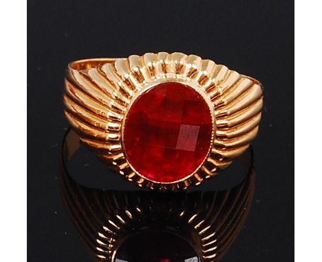 A mens 18ct gold and ruby set gents signet ring, the large oval cut ruby in a reeded surround, size W Condition Report / Extr