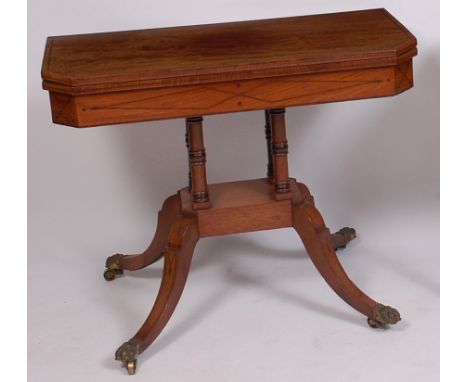 A Regency mahogany pedestal card table, the fold-over top with satinwood stringing and canted corners, opening to reveal baiz