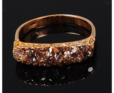 An 18ct gold and diamond five stone ring, the graduated old brilliants in a chased line setting, total diamond weight estimat