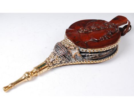 A pair of 19th century Continental walnut and brass fireside bellows, the obverse relief carved with profile portrait of a yo