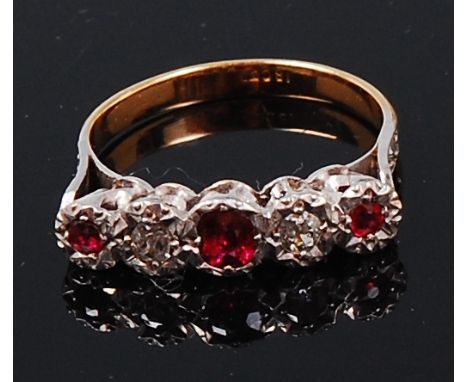 An 18ct gold, ruby and diamond dress ring, arranged as three illusion set round cut rubies dispersed with two illusion set ol