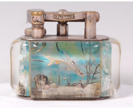 A Dunhill Aquarium table lighter, the lucite panels intaglio decorated with a Japanese fighting fish to one side, and two sim