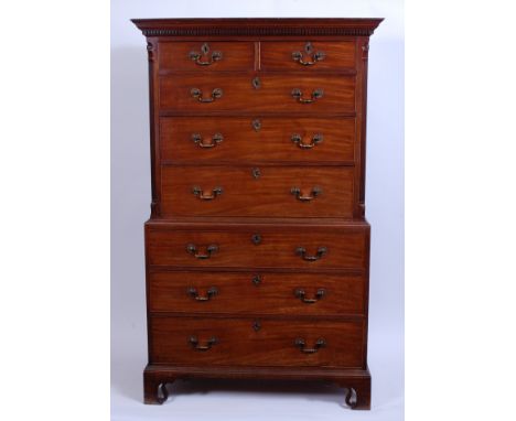 A George III mahogany chest-on-chest, the upper section having a dentil moulded cornice and fluted canted corners flanking tw