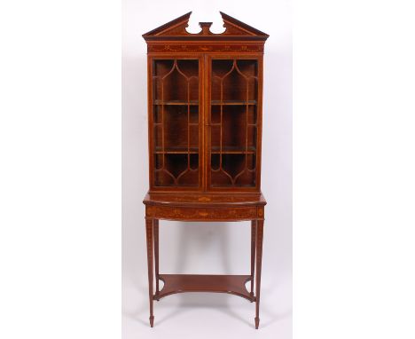 A Sheraton Revival fiddleback mahogany and inlaid cabinet by Maple & Co, having an architectural broken pediment above a fine