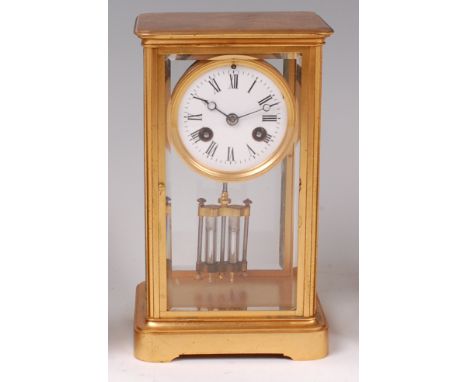 A circa 1900 lacquered brass cased mantel clock, having an unsigned white enamel dial with Roman numerals, twin winding holes