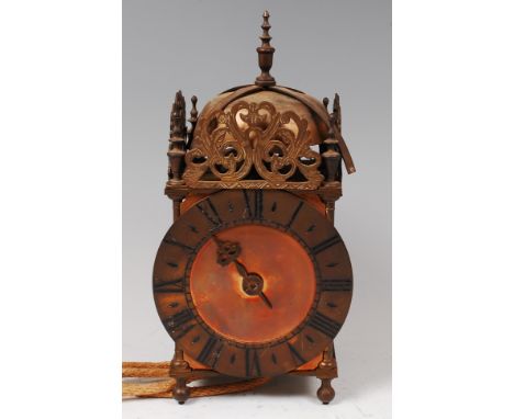 A Victorian brass lantern clock, in the 17th century style, having a bell top, pierced brass frieze, chapter ring with single