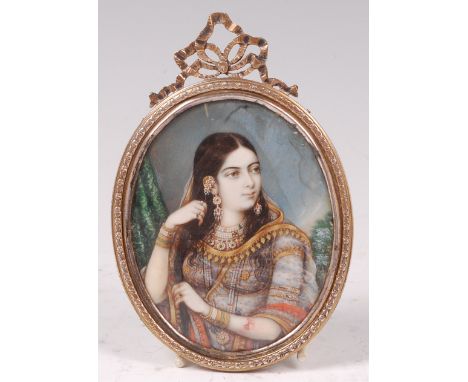 19th century Indian school - Half length portrait of a princess, adorned with jewellery, miniature watercolour on ivory, 9 x 