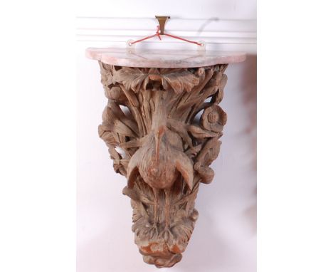 A 19th century carved limed wood wall bracket, having a veined marble top and carved as a heron amidst bullrushes, h.57cm